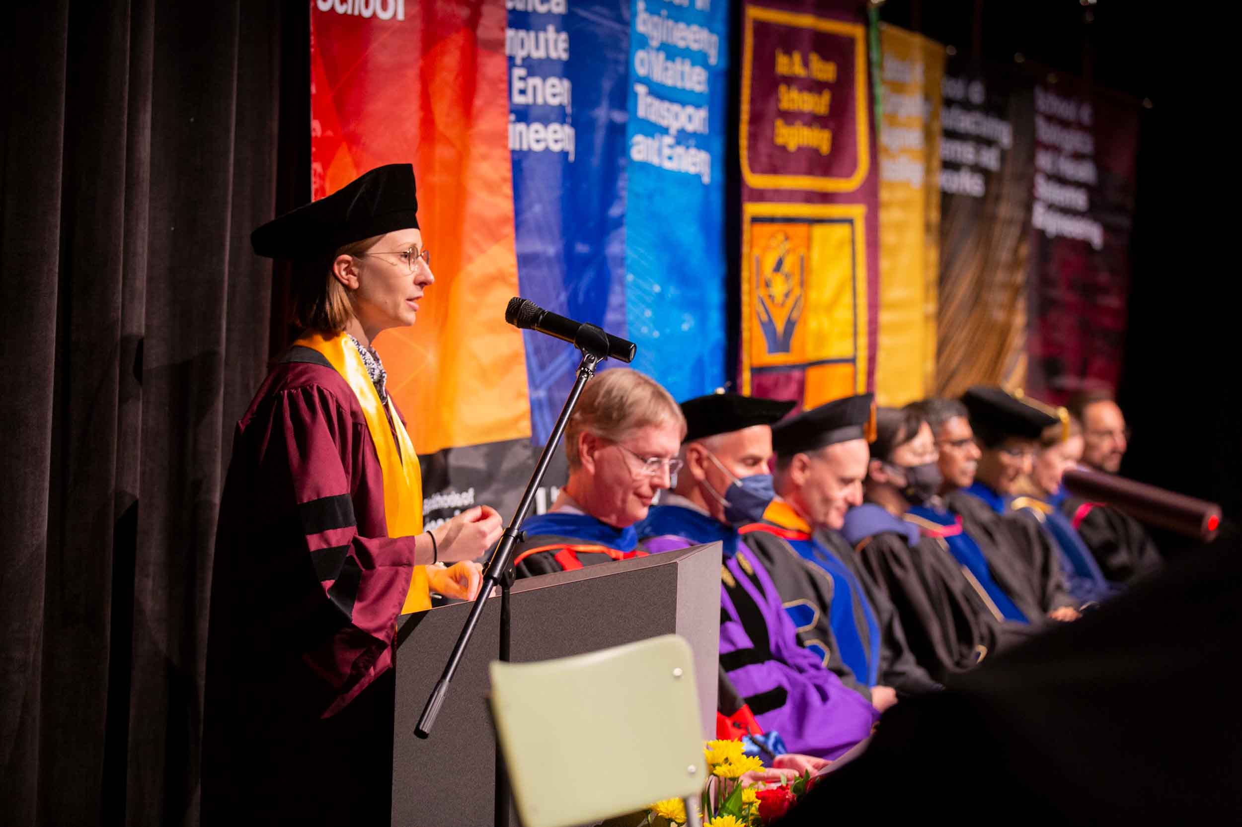 Devin Bowes, the Spring 2022 Dean's Dissertation Award winner, speaks at the PhD hooding ceremony.